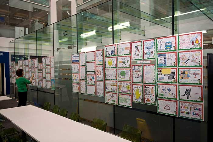 Woman placing posters on glass wall