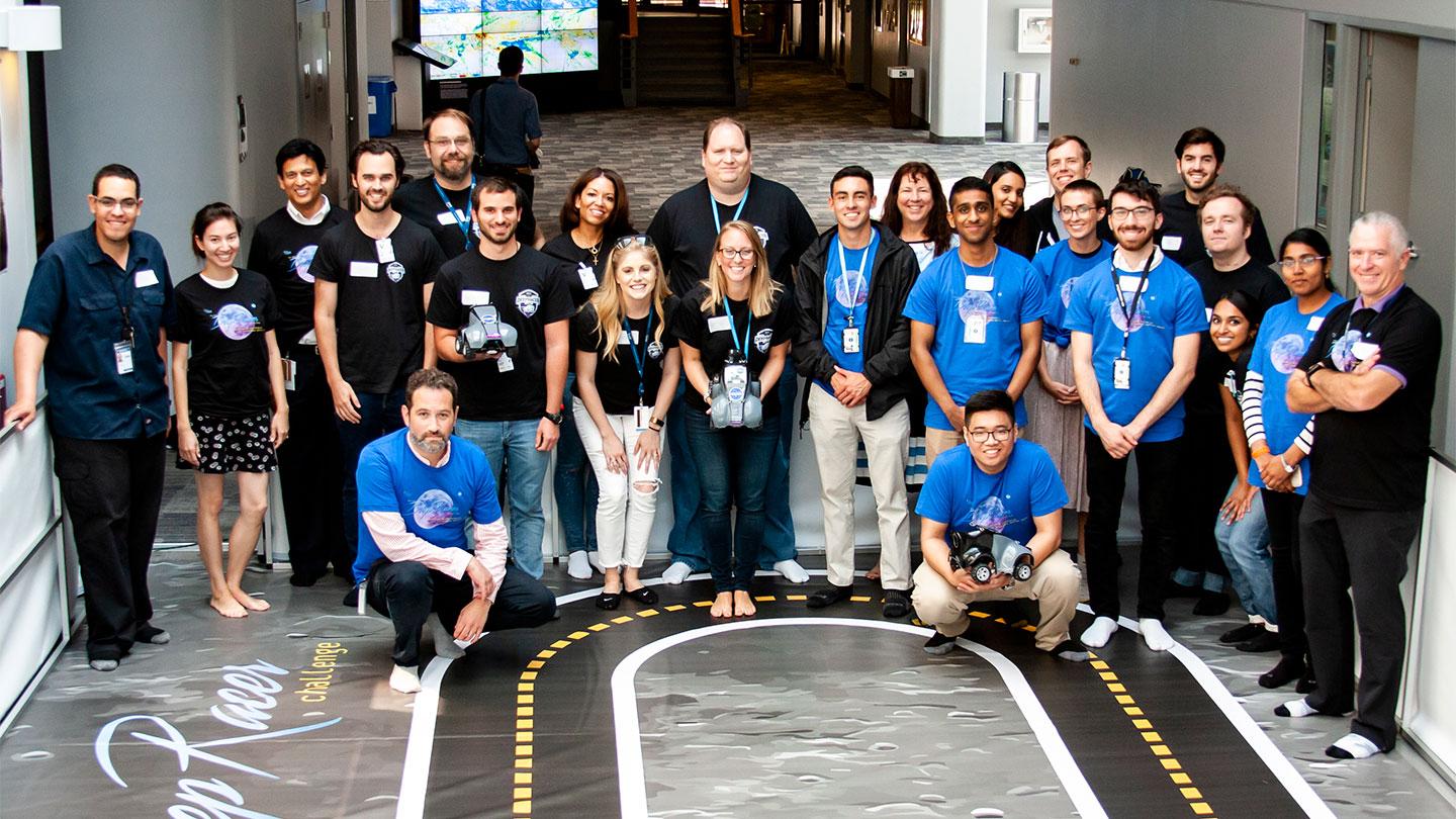 Race participants take a break from the competition. NASA and KBR interns and other employees faced off during the DeepRacer event to see whose vehicle could speed around a track the fastest. 