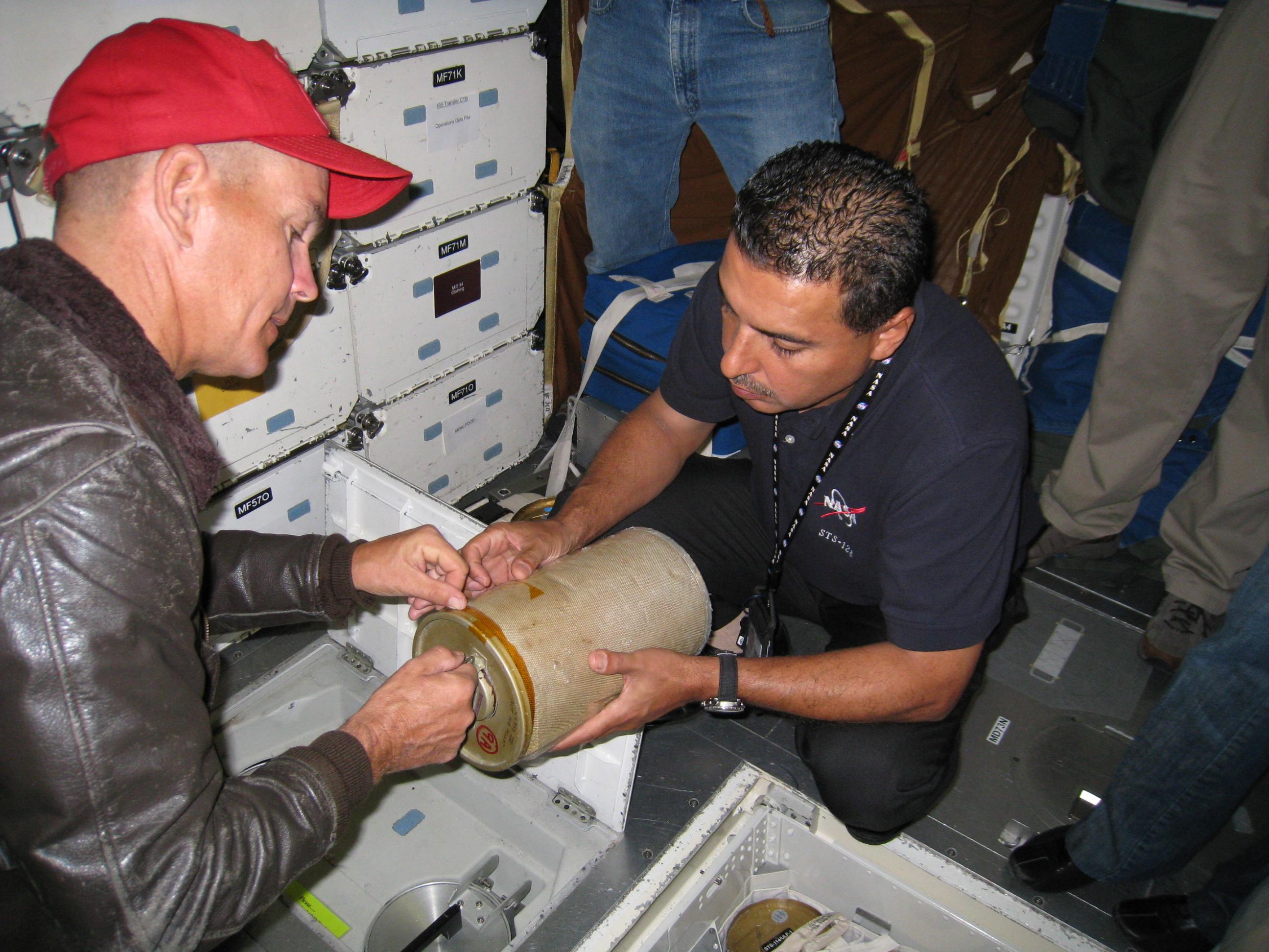 Pictured above with Jose is STS-128 commander CJ Sturckow, played by Garret Dillahunt in the movie.  CJ was rarely seen without his red, Marine Corps baseball cap. Photo Credit: NASA